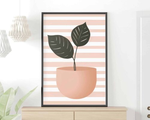 יצירת אמנות ממוסגרת בשם "תמונה למטבח בעיצוב מינימליסטי עציץ על רקע פסים ורודים", המציגה איור מינימליסטי של עציץ עם שני עלים ירוקים גדולים על רקע פסים אופקיים ורודים ולבנים. המסגרת ממוקמת על גבי ארון בצבע בז' עם צמח קטן משמאלו.