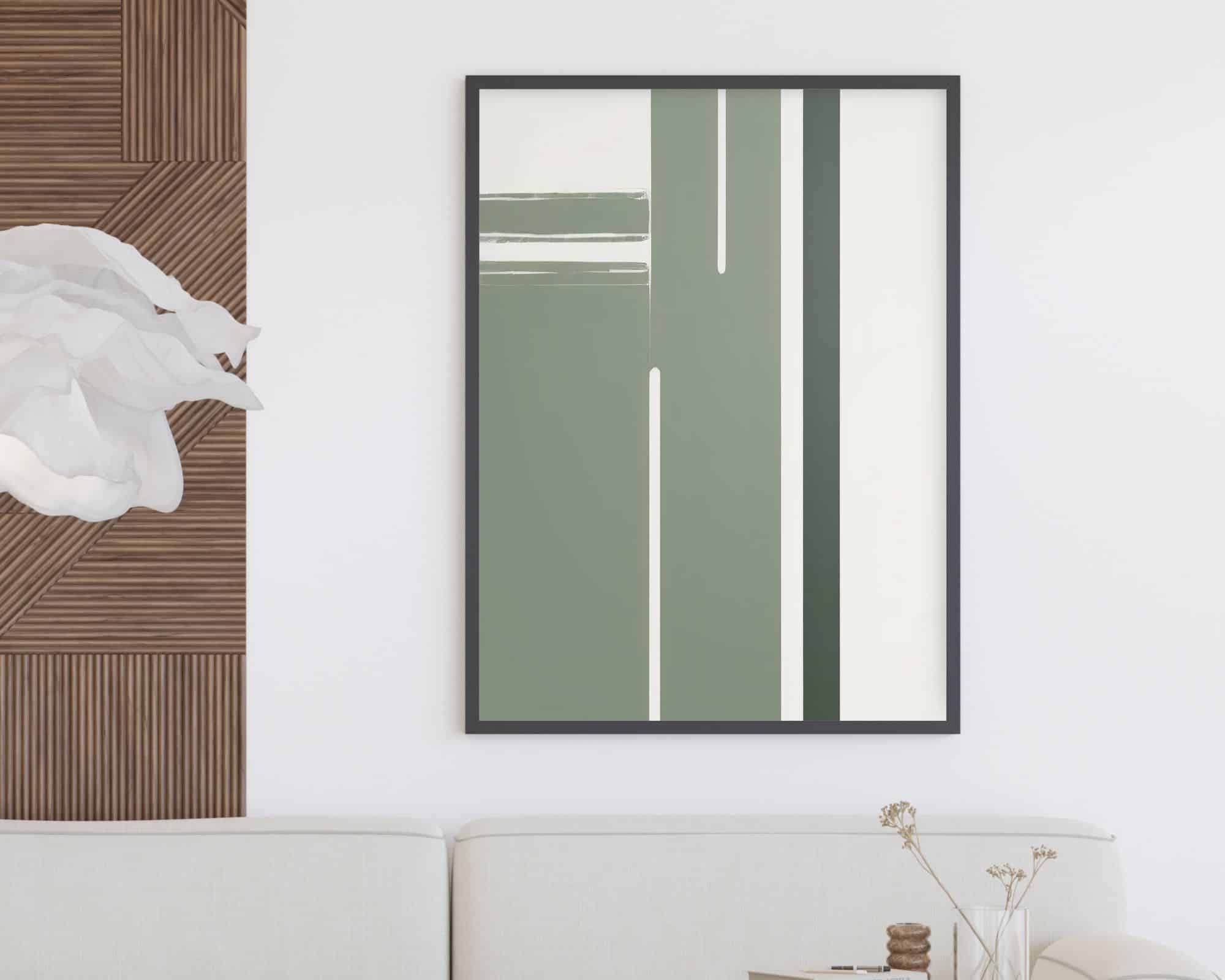 סלון מודרני הכולל "תמונה לחדר שינה נוסח מנימליסטי בצבעים לבן וירוק מרווה דגם א'", ממוסגר בשחור ונתלה על קיר לבן. בחדר יש ספה לבנה, עיצוב עץ, פריט קיר דמוי פרח לבן ושולחן קטן עם גבעולים מיובשים באגרטל.