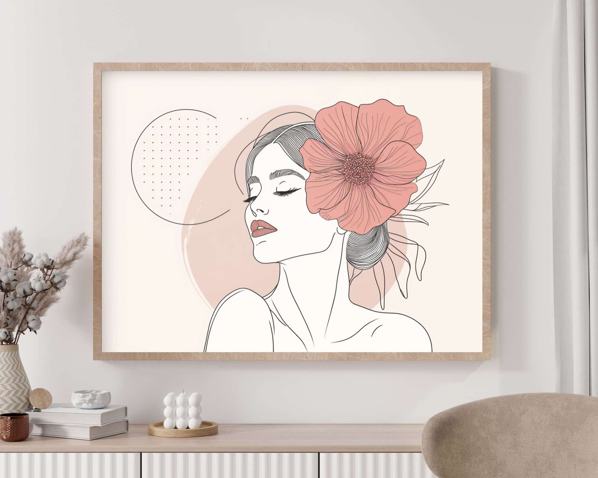 2585mo1 יצירת אמנות ממוסגרת בשם "תמונה מעל המיטה בעיצוב מינימליסטי אישה עם פרח ורוד", המתארת ציור קו מינימליסטי של אישה בעיניים עצומות, עונדת פרח ורוד גדול בשערה. הרקע כולל צורות ונקודות מופשטות. המסגרת מותקנת על קיר מעל ארון לבן המעוטר בפריטי נוי.